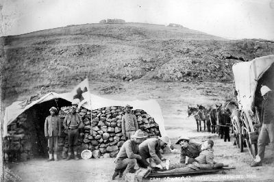 Captain Dr. Wreford attending a wounded man